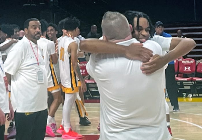 Northeast-AA senior Cameron Albury gets bear-hugged by coach Roger O’Dea during the awards ceremony for the MPSSAA Class 3A boys basketball state championship game. Albury led a furious fourth quarter comeback as the Eagles defeated St. Charles, 69-66.
